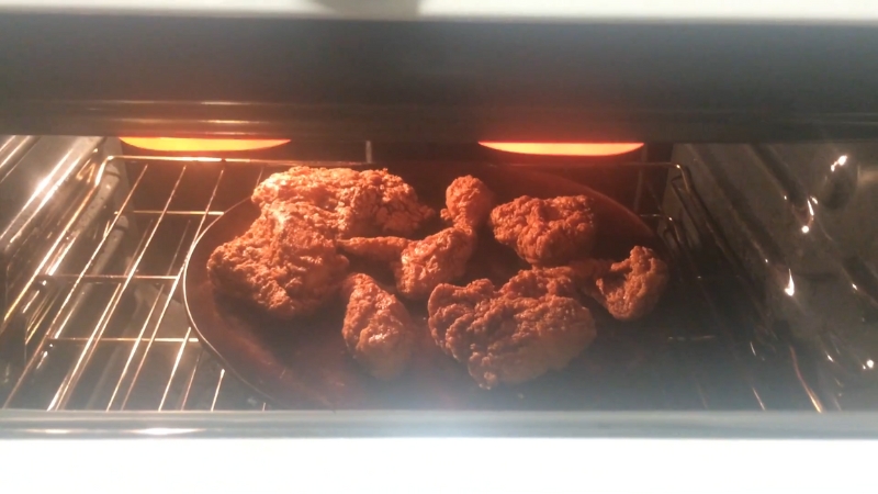 Buffalo wings on a plate inside an oven