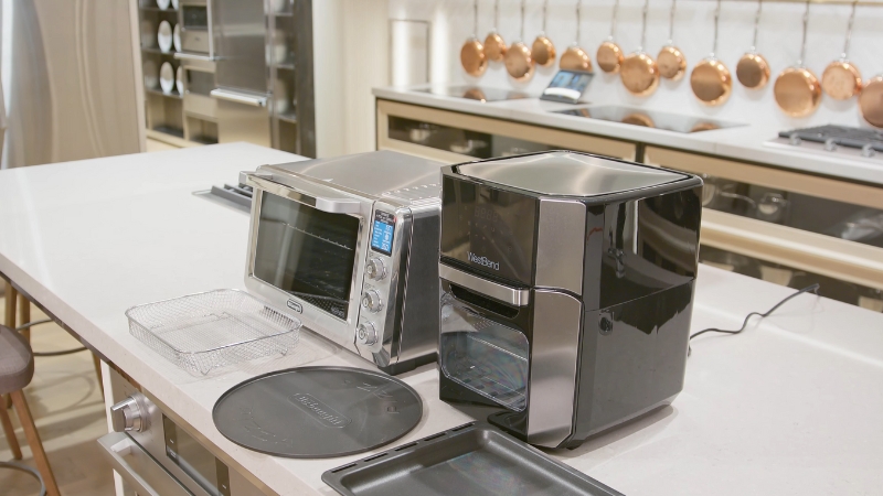 A Comparison of An Air Fryer and An Oven Placed Side by Side on A Kitchen Countertop